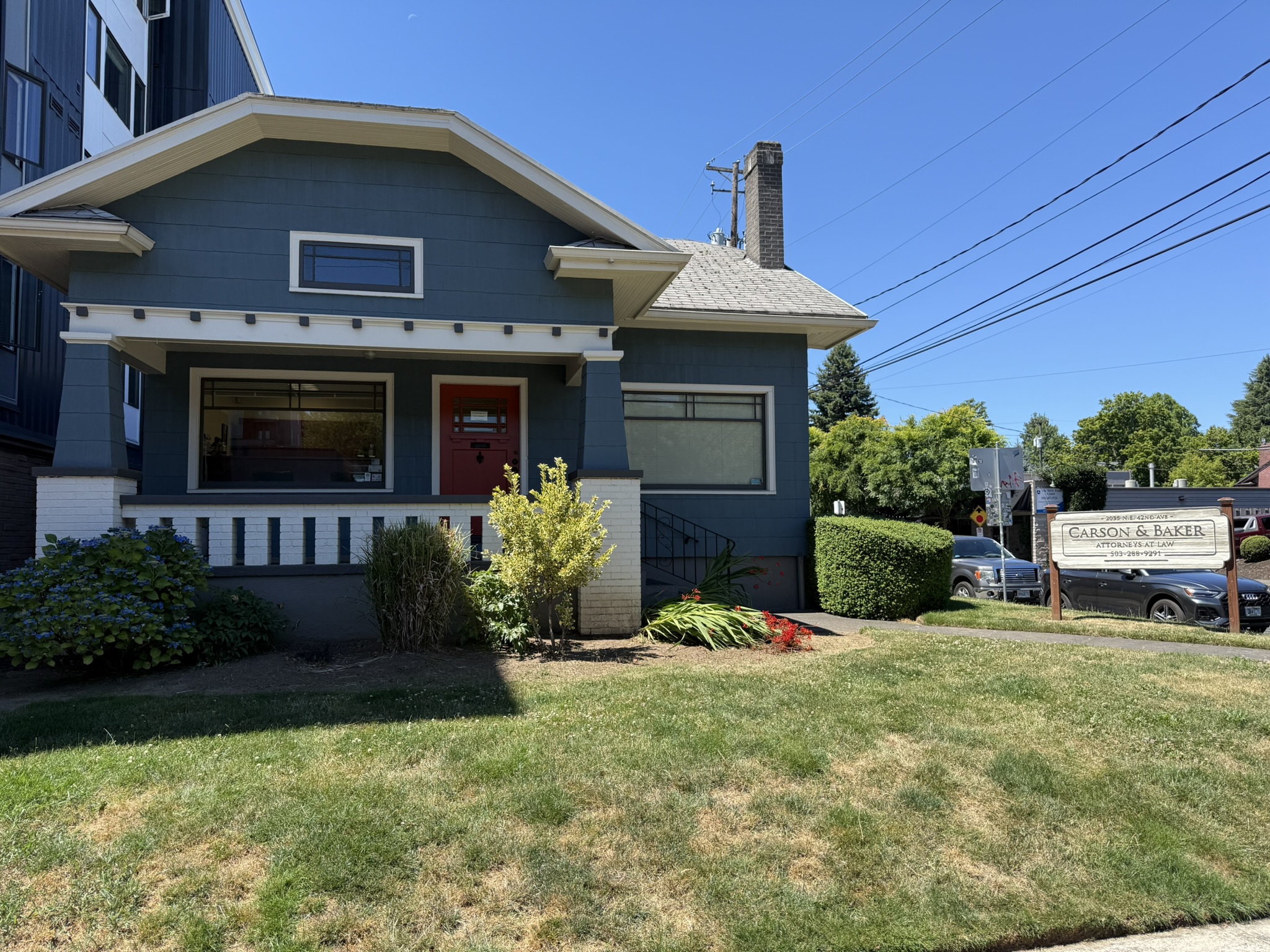 Photo of Carson Seegmuller & Baker's office building located on the corner of 42nd Avenue and Tillamook Street in Portland Oregon. It is a craftsman style home with blue siding and white trim.